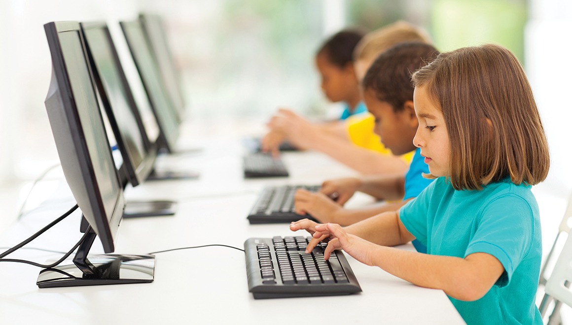 Group of elementary school students in computer class